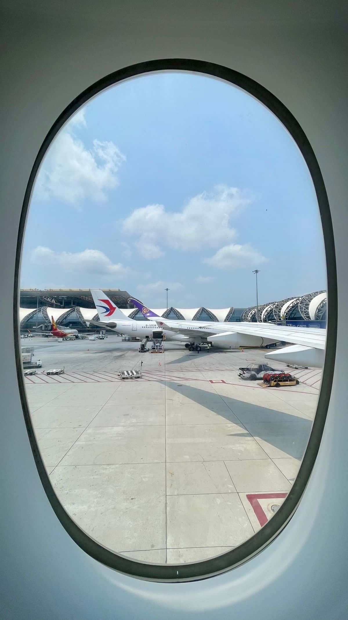 Calm view of the tarmac and open sky at Suvarnabhumi Airport, Bangkok