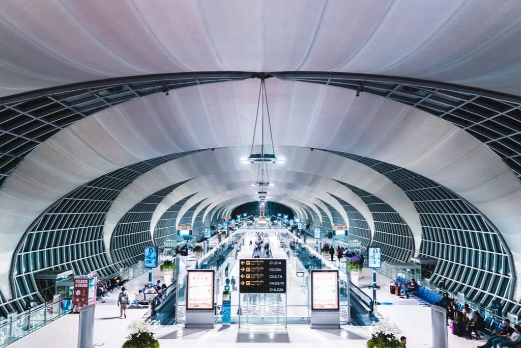 Suvarnabhumi Airport terminal hall with travelers heading to immigration and departure gates