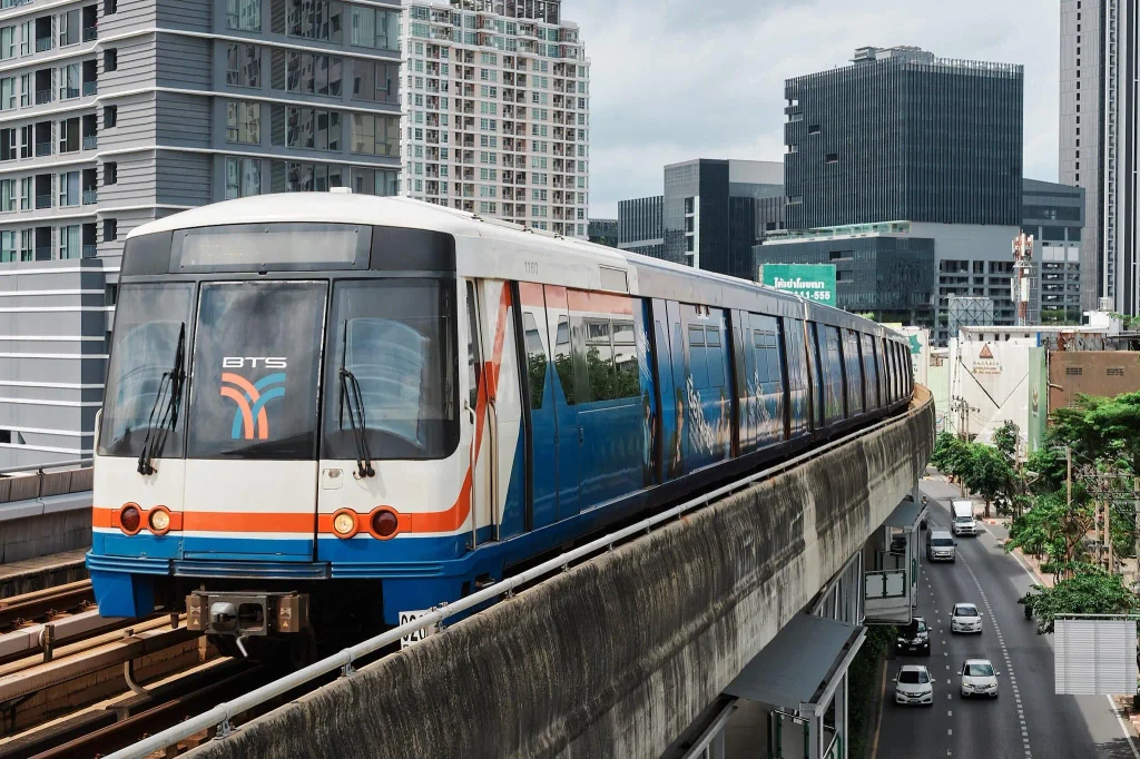 A BTS Skytrain arriving at a station platform in central Bangkok
