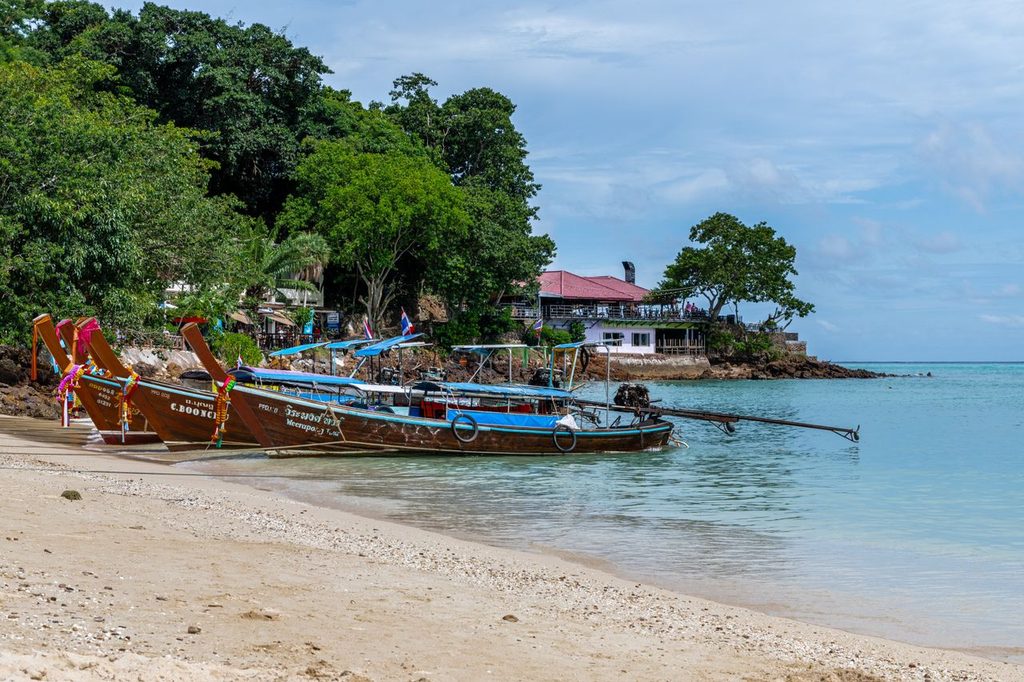 Longtail boats at anchor in a sheltered bay near Rawai on Phuket's east coast