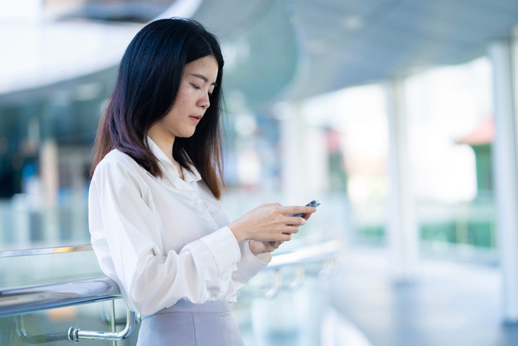 Woman checking eSIM with her smartphone
